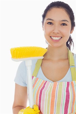 simsearch:400-06863604,k - Smiling woman in apron with broom Photographie de stock - Aubaine LD & Abonnement, Code: 400-06863583