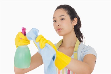 rubber apron woman - Woman wiping surface with cloth wearing apron and rubber gloves Stock Photo - Budget Royalty-Free & Subscription, Code: 400-06863594