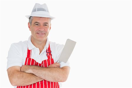 Smiling butcher with meat cleaver and crossed arms Stock Photo - Budget Royalty-Free & Subscription, Code: 400-06863634