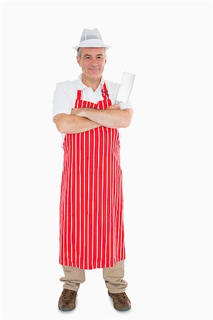 Smiling butcher in apron with meat cleaver and crossed arms Stock Photo - Budget Royalty-Free & Subscription, Code: 400-06863639