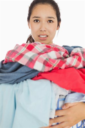 dirty clothes hamper - Frowning woman overwhelmed with amount of dirty laundry Stock Photo - Budget Royalty-Free & Subscription, Code: 400-06863694