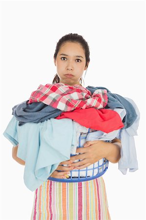 Tired woman in apron holding heavy full laundry bakset Stock Photo - Budget Royalty-Free & Subscription, Code: 400-06863695