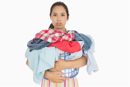 Frowning young woman holding basket which is full of dirty laundry Stock Photo - Budget Royalty-Free & Subscription, Code: 400-06863696
