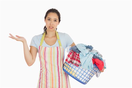 Puzzled look young woman holding laundry basket full of dirty laundry with wrinkled hands Stock Photo - Budget Royalty-Free & Subscription, Code: 400-06863716