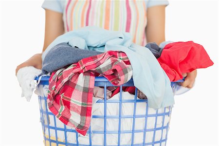 Woman in apron carrying full laundry basket Stock Photo - Budget Royalty-Free & Subscription, Code: 400-06863718