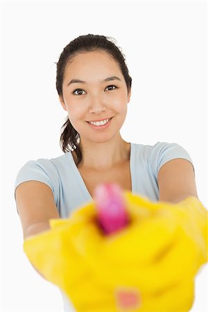 spray on camera - smiling woman pointing spray bottle at the camera on a white background Stock Photo - Budget Royalty-Free & Subscription, Code: 400-06863744