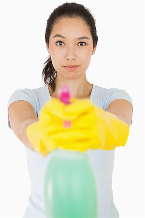 spray on camera - Brunette woman pointing spray bottle at camera Stock Photo - Budget Royalty-Free & Subscription, Code: 400-06863740
