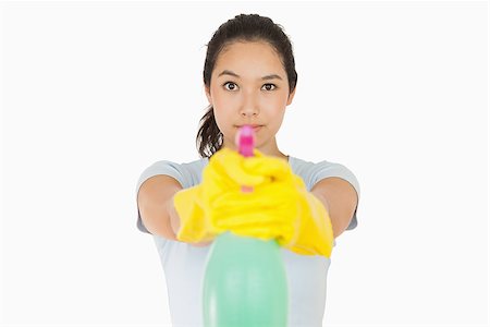 spray on camera - Woman pointing a spray bottle at the camera on a white background Stock Photo - Budget Royalty-Free & Subscription, Code: 400-06863741