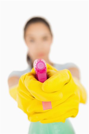 spray on camera - Confident woman pointing a spray bottle at the camera on a white background Stock Photo - Budget Royalty-Free & Subscription, Code: 400-06863743