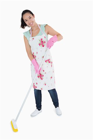 full body white background apron - Happy woman standing and sweeping floor Stock Photo - Budget Royalty-Free & Subscription, Code: 400-06863902