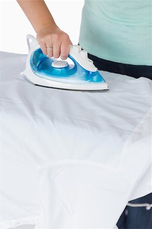 Woman ironing clothes on an ironing table Stock Photo - Budget Royalty-Free & Subscription, Code: 400-06863946
