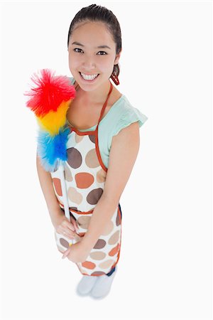 Happy woman holding feather duster Stock Photo - Budget Royalty-Free & Subscription, Code: 400-06863967