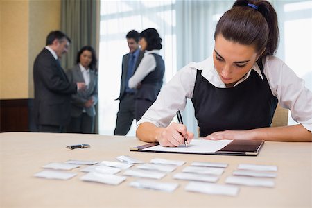 registration - Businesswoman working at welcome desk at conference Stock Photo - Budget Royalty-Free & Subscription, Code: 400-06874007