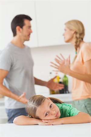 Couple arguing behind a sad girl in the kitchen Stock Photo - Budget Royalty-Free & Subscription, Code: 400-06874083