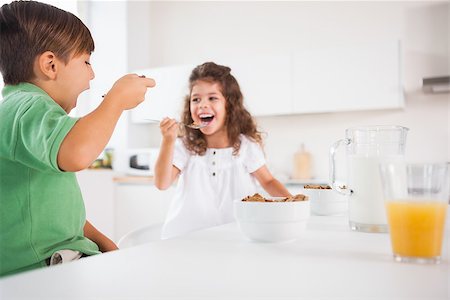 simsearch:649-07648559,k - Two children eating cereal in kitchen Foto de stock - Super Valor sin royalties y Suscripción, Código: 400-06874192