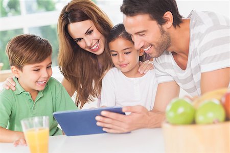 Family using a tablet pc in kitchen Stock Photo - Budget Royalty-Free & Subscription, Code: 400-06874203