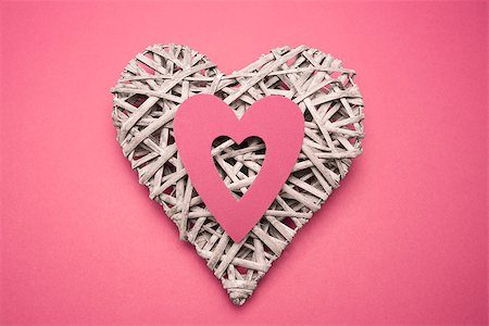 simsearch:400-06873734,k - Wicker heart ornament with paper cut out on pink background Stock Photo - Budget Royalty-Free & Subscription, Code: 400-06874268