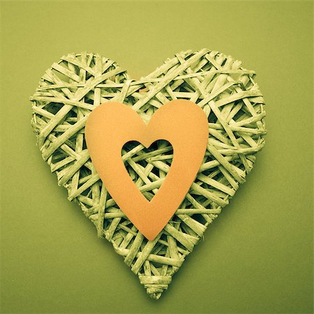 simsearch:400-06873734,k - Wicker heart ornament with yellow paper cut out on green background Stock Photo - Budget Royalty-Free & Subscription, Code: 400-06874277