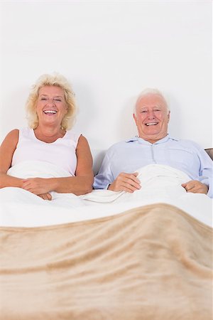simsearch:6109-06781886,k - Aged couple lying on the bed and smiling Stock Photo - Budget Royalty-Free & Subscription, Code: 400-06874448