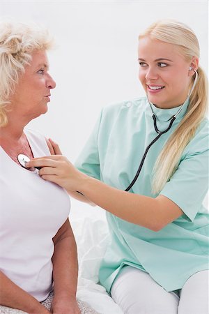 Home nurse and patient talking while listening to stethoscope Stock Photo - Budget Royalty-Free & Subscription, Code: 400-06874479