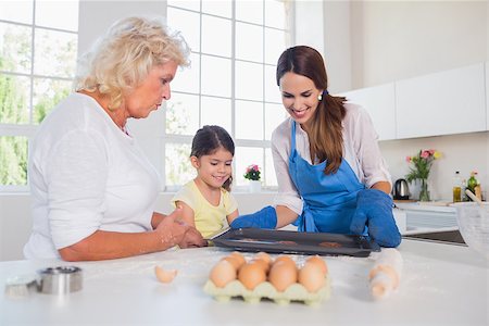 Girl preparing cookies with her mother and grandmother in the kitchen Stock Photo - Budget Royalty-Free & Subscription, Code: 400-06874565