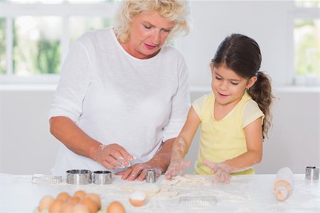 Granddaughter and grandmother preparing cookies together in the kichen Stock Photo - Budget Royalty-Free & Subscription, Code: 400-06874562