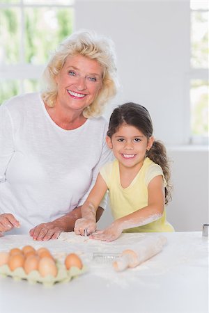Granddaughter and grandmother preparing bicuits together in the kichen Stock Photo - Budget Royalty-Free & Subscription, Code: 400-06874563