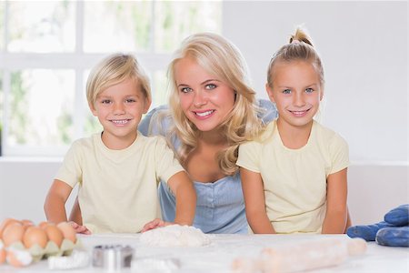 Family smiling at the camera with the baking tools in kitchen Stock Photo - Budget Royalty-Free & Subscription, Code: 400-06874574