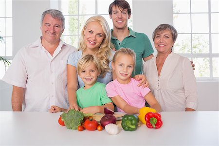 Family smiling with vegetables in kitchen Stock Photo - Budget Royalty-Free & Subscription, Code: 400-06874593