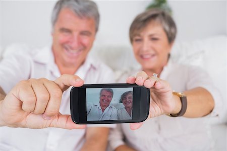 Old lovers taking a picture of themselves with smartphone Stock Photo - Budget Royalty-Free & Subscription, Code: 400-06874609