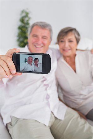 picture of woman with old mobile phone - Old man taking a picture of him and his wife with a smartphone Stock Photo - Budget Royalty-Free & Subscription, Code: 400-06874611