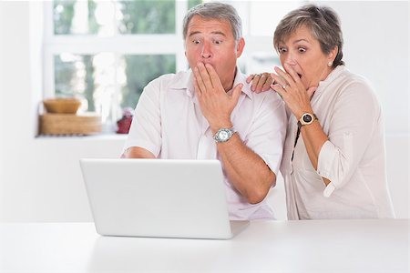 Old couple surprised in front of a laptop together Stock Photo - Budget Royalty-Free & Subscription, Code: 400-06874647