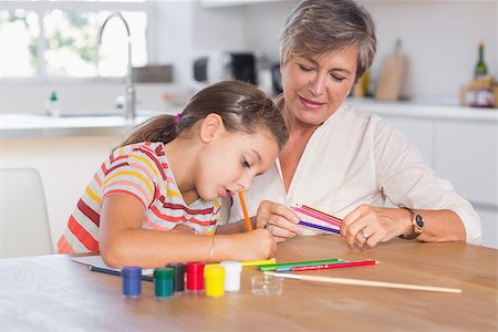 Child drawing with her grandmother in kitchen Stock Photo - Budget Royalty-Free & Subscription, Code: 400-06874711