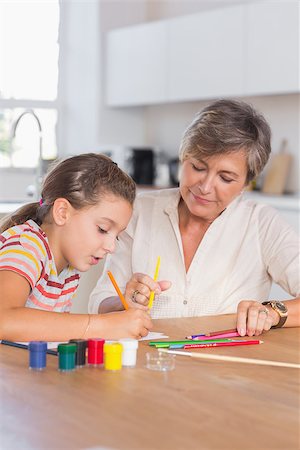 Child drawing with her grandmother in kitchen Stock Photo - Budget Royalty-Free & Subscription, Code: 400-06874712