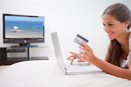 simsearch:400-07474252,k - Young woman doing online shopping in the living room Stock Photo - Budget Royalty-Free & Subscription, Code: 400-06874736