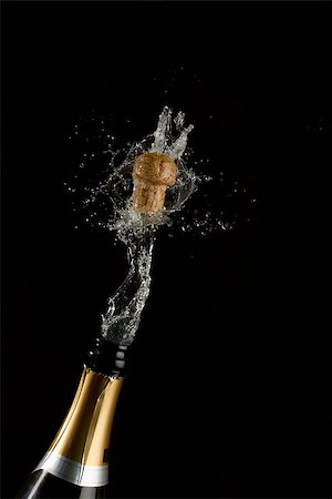 popping champagne cork - Champagne cork popping on black background Stock Photo - Budget Royalty-Free & Subscription, Code: 400-06874733