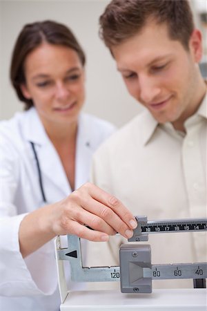 Medical scale getting adjusted by doctor Stock Photo - Budget Royalty-Free & Subscription, Code: 400-06874782