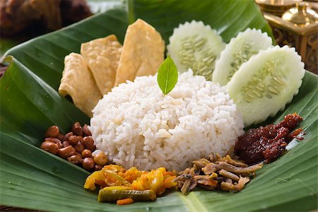 nasi lemak, a traditional malay curry paste rice dish served on a banana leaf Stock Photo - Budget Royalty-Free & Subscription, Code: 400-06874819