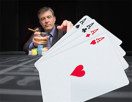 simsearch:400-06802094,k - Gambler at the poker table with digital hand of four aces in foreground Foto de stock - Super Valor sin royalties y Suscripción, Código: 400-06875658