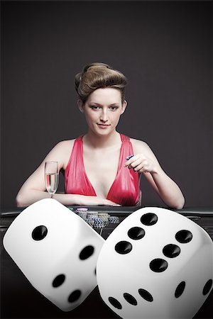Attractive gambler betting on digital dice in foreground Stock Photo - Budget Royalty-Free & Subscription, Code: 400-06875666