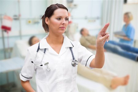simsearch:400-06875952,k - Nurse pressing on invisible screen in hospital ward Stockbilder - Microstock & Abonnement, Bildnummer: 400-06875777