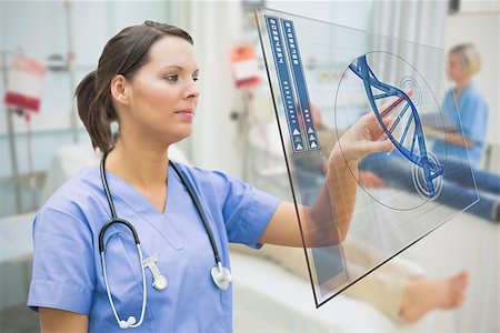simsearch:400-06875952,k - Nurse touching screen displaying blue DNA helix data in hospital ward Stockbilder - Microstock & Abonnement, Bildnummer: 400-06875773