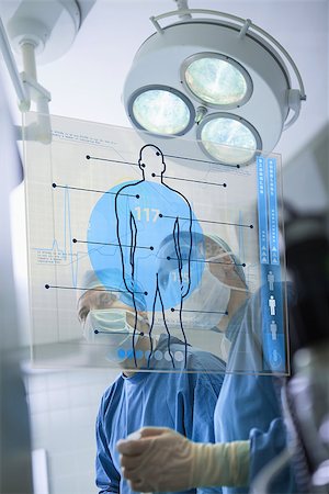 simsearch:400-06875952,k - Two surgeons working with a medical interface in the hospital Stockbilder - Microstock & Abonnement, Bildnummer: 400-06875946