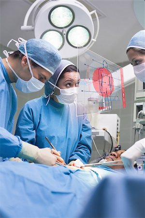 simsearch:400-06875952,k - Surgery team using a new technology on surgery Stockbilder - Microstock & Abonnement, Bildnummer: 400-06875949
