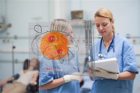simsearch:400-06875952,k - Serious nurses looking at an interface during the blood donation in a hospital Stockbilder - Microstock & Abonnement, Bildnummer: 400-06875954