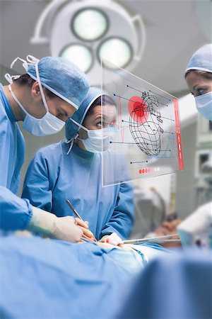 simsearch:400-06875952,k - Surgeons using an interface for operating in a hospital Stockbilder - Microstock & Abonnement, Bildnummer: 400-06875950