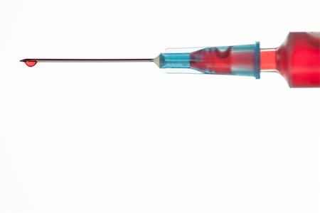 Drop of blood on end of syringe on white background Stock Photo - Budget Royalty-Free & Subscription, Code: 400-06876229