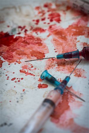 Two syringes lying on blood splatters on dirty floor Stock Photo - Budget Royalty-Free & Subscription, Code: 400-06876269