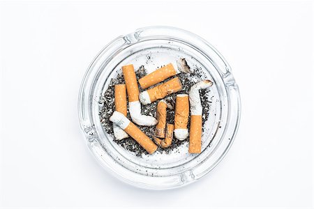 Overhead of full ashtray on white background Photographie de stock - Aubaine LD & Abonnement, Code: 400-06876309