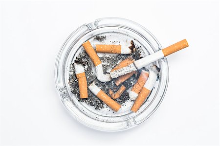 simsearch:400-06876304,k - Overhead of burning cigarette in ashtray on white background Stock Photo - Budget Royalty-Free & Subscription, Code: 400-06876310